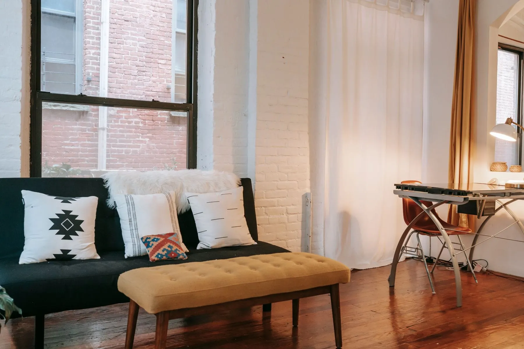 Bright, freshly painted living room with hardwood floors and large windows