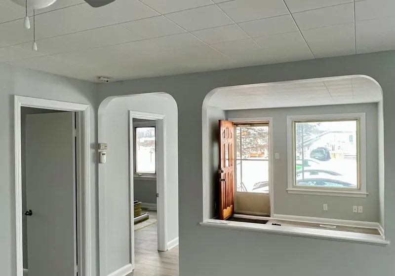 Living room with grey walls, ceiling fan and an arched opening to the entry, Reneal Street unit